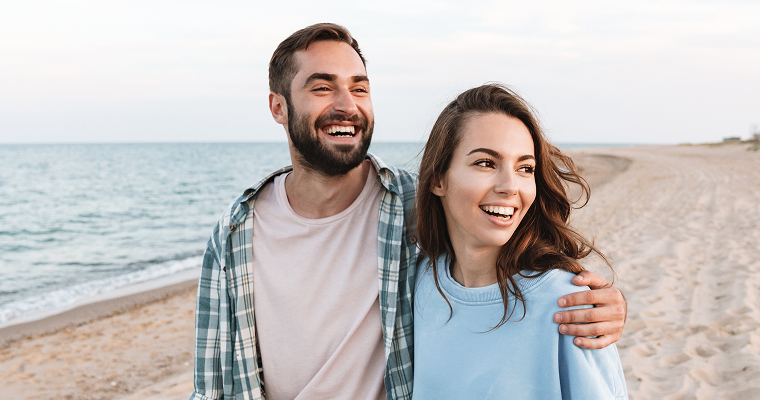 A couple on a beach smiling