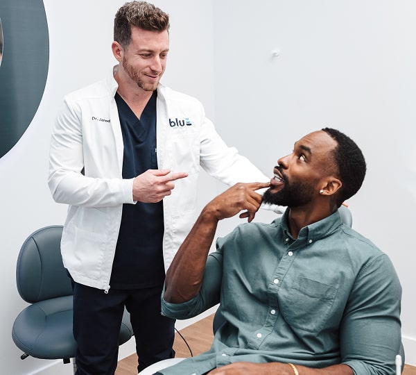 Comprehensive Dental Exams to Keep You Healthy. A man is smiling with his dentist