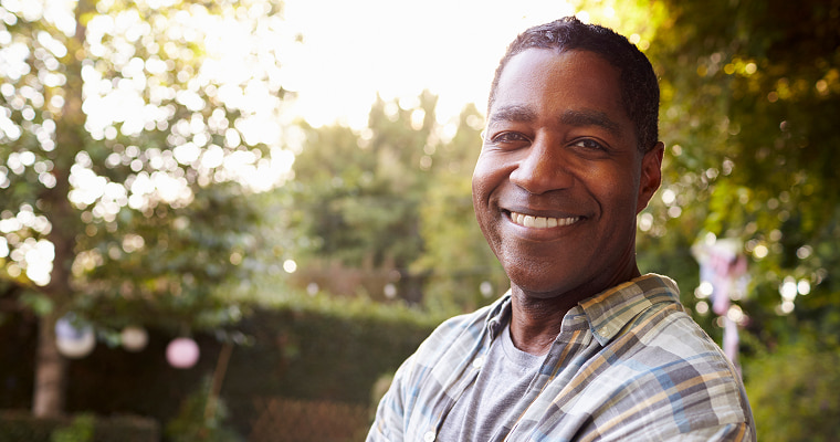 A man standing outside and smiling