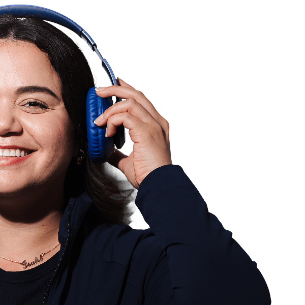 Book Today at Blu Dental Miami Shores—Your Smile Deserves This! A woman is smiling while listening to the music
