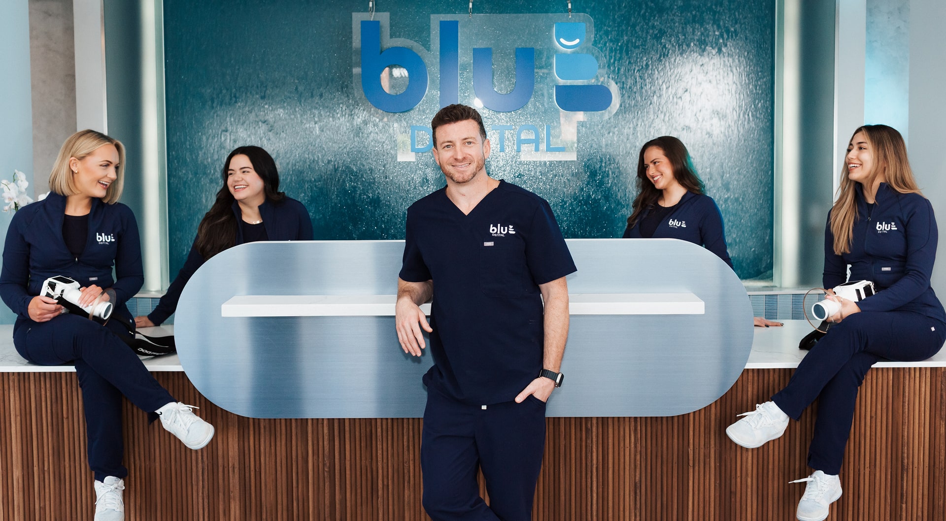 Blu Dental team at front desk - all welcomely smiling