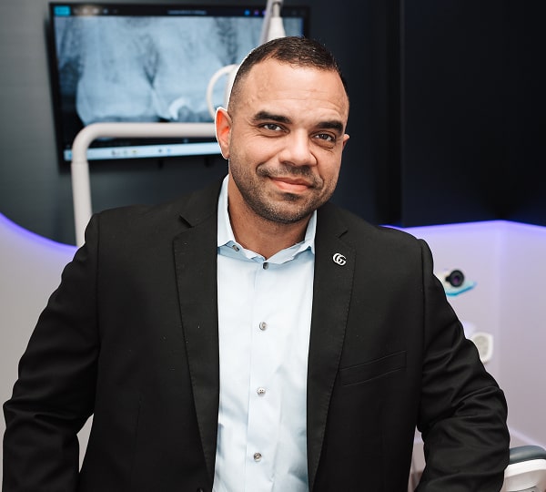 Rebuild Jawbone for Implants with Dental Bone Grafting. Dentist in a suite is smiling