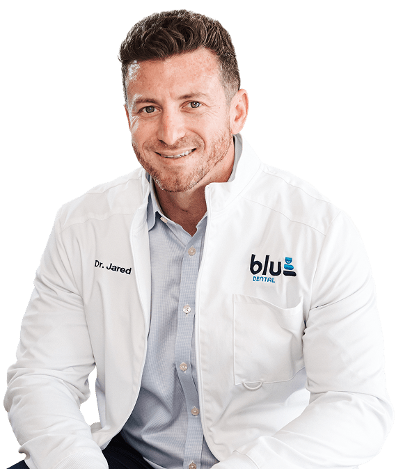 Secure Your Smile with Our Lifetime Warranty at Blu Dental Miami Shores. Dentist is happily smiling