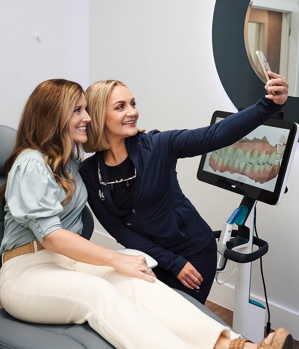 Stay on Top of Your Oral Health with a Fast, Gentle Cleaning. Dentist with her smiling patient