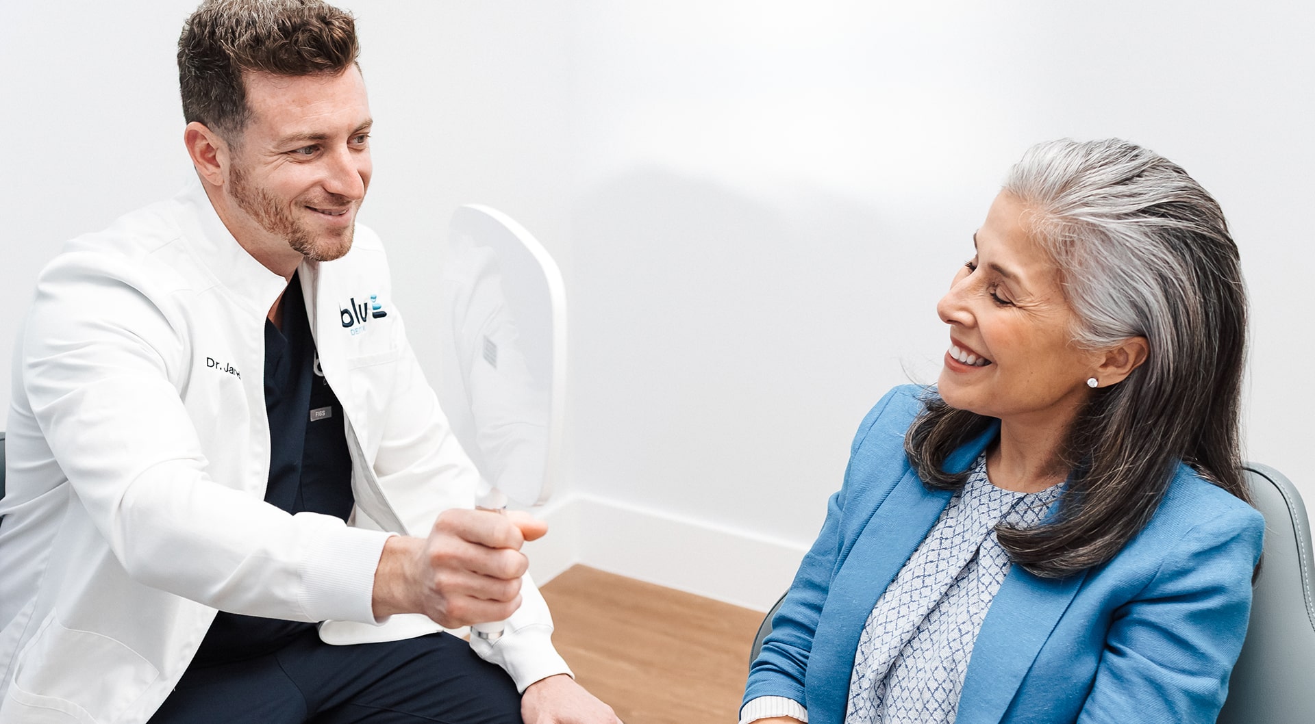 Dentist with his smiling patient smiling