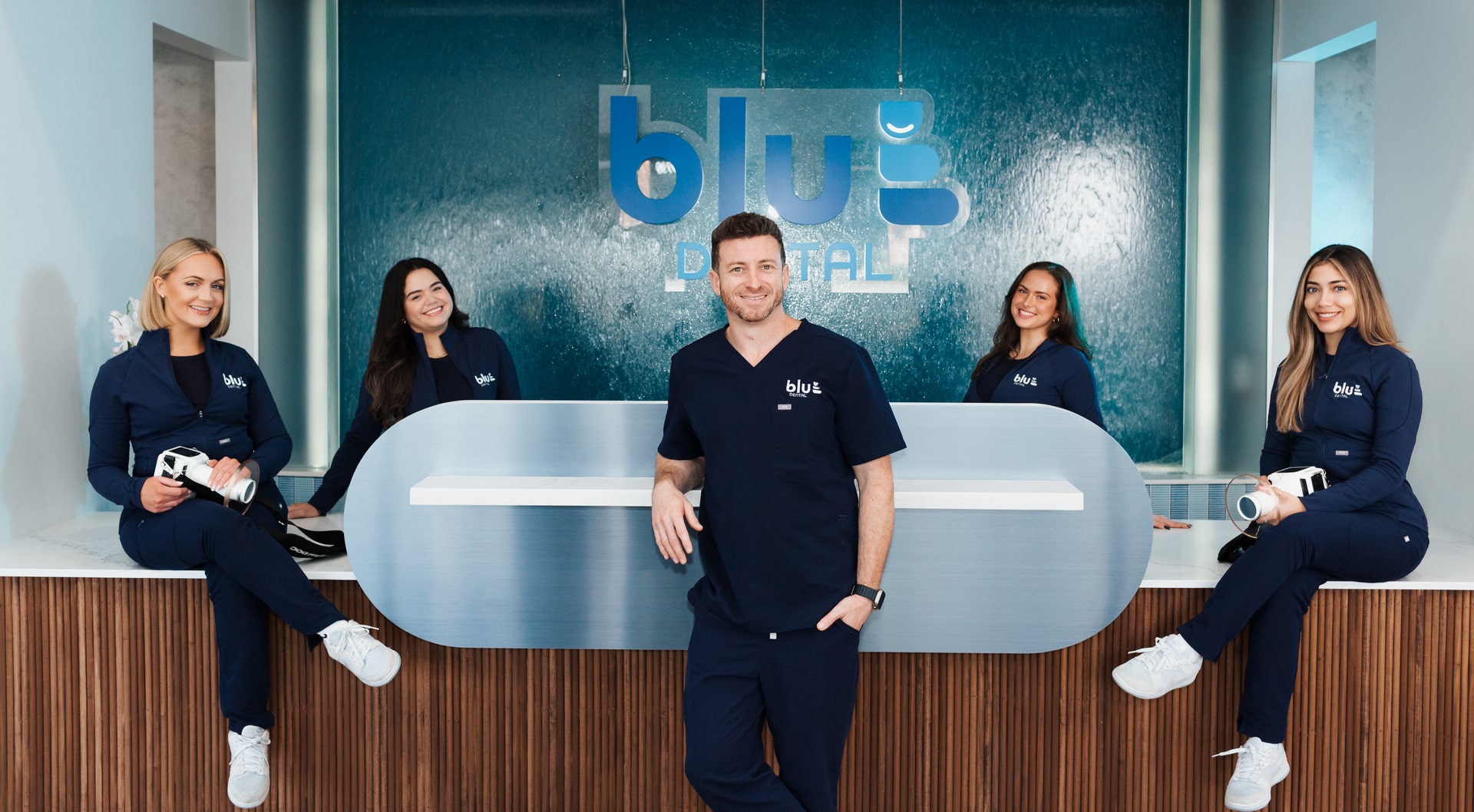 Dr. Jared is joyfully smiling with his happy team
