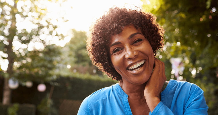 A female smiles after her cosmetic dental treatment