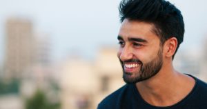 A man smiling after his dental treatment