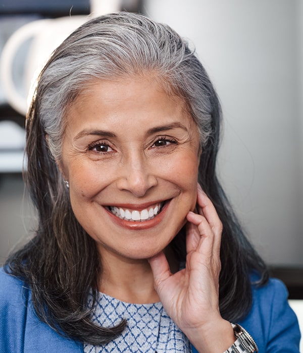 Transform Your Smile with a Personalized Smile Makeover Plan. A woman is smiling after smile makeover