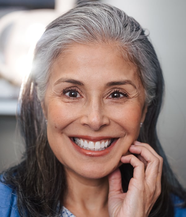 Transform Your Smile with Custom Veneers. A woman is smiling