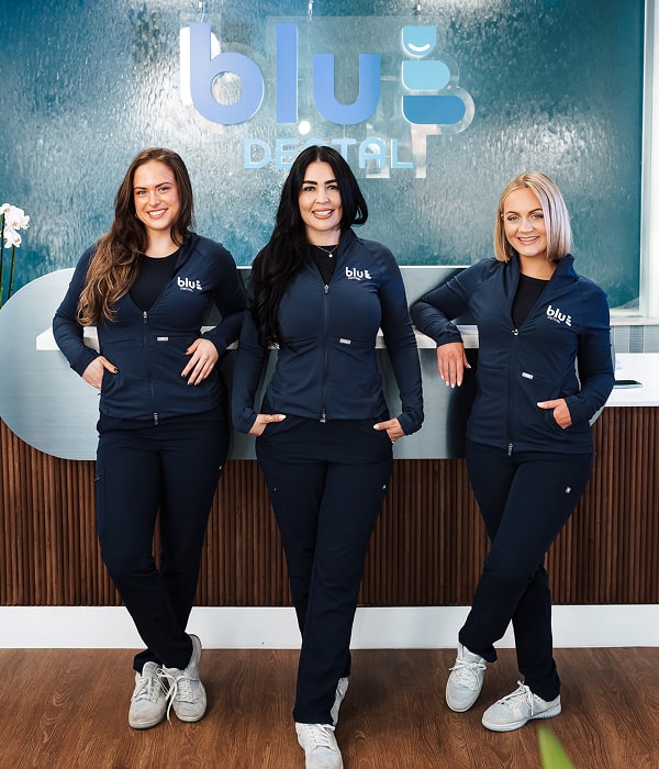 Blu Dental front desk tam all smiling