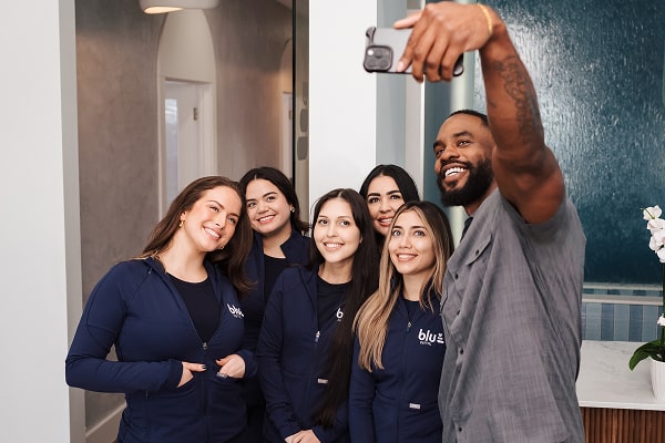 Oral Care Elite Club – Smarter Dental Coverage Starts Here. Blu Dental team making selfie with a joyful and happy patient