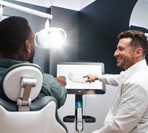 Experience Comfortable, Time-Saving Dentistry at Blu Dental. Dentist and a patient in a dental chair are smiling