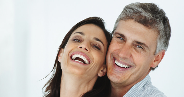 A couple smiling and embracing