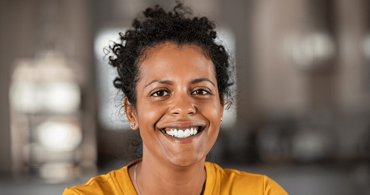 A woman smiles after her dental treatment