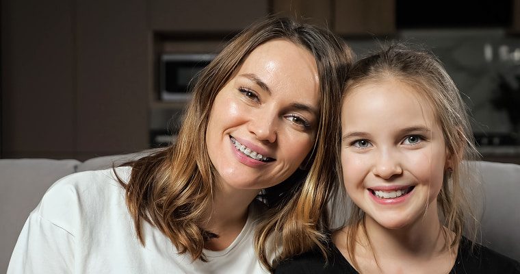 Mother and daughter smiling together