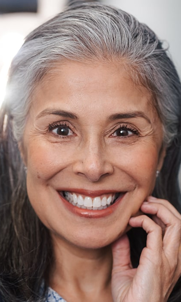 Transform Your Smile with Custom Veneers A female patient of Blu Dental smiling after her treatment