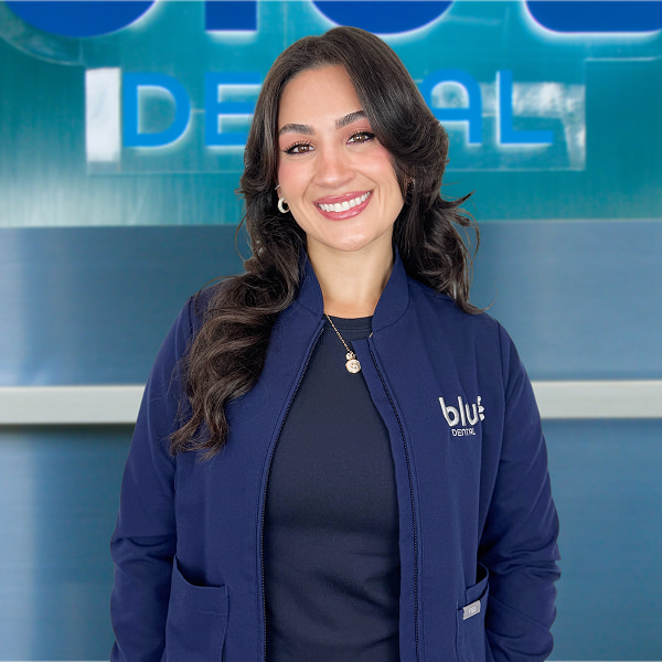 Why Blu Dental Is Your Best Choice for Porcelain Veneers Dr. Chloe in front of the Blu Dental logo