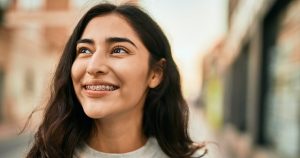 A woman in braces smiling